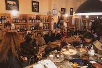 a group of people sitting around a table in a restaurant