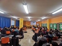 a group of people sitting in a classroom